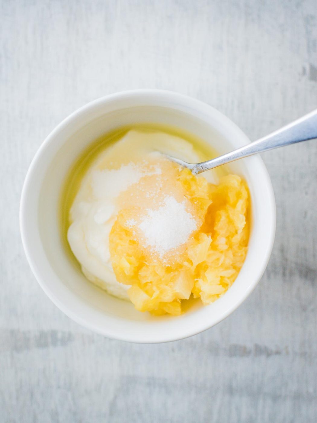 ingredients for creamy pineapple dipping sauce in a bowl