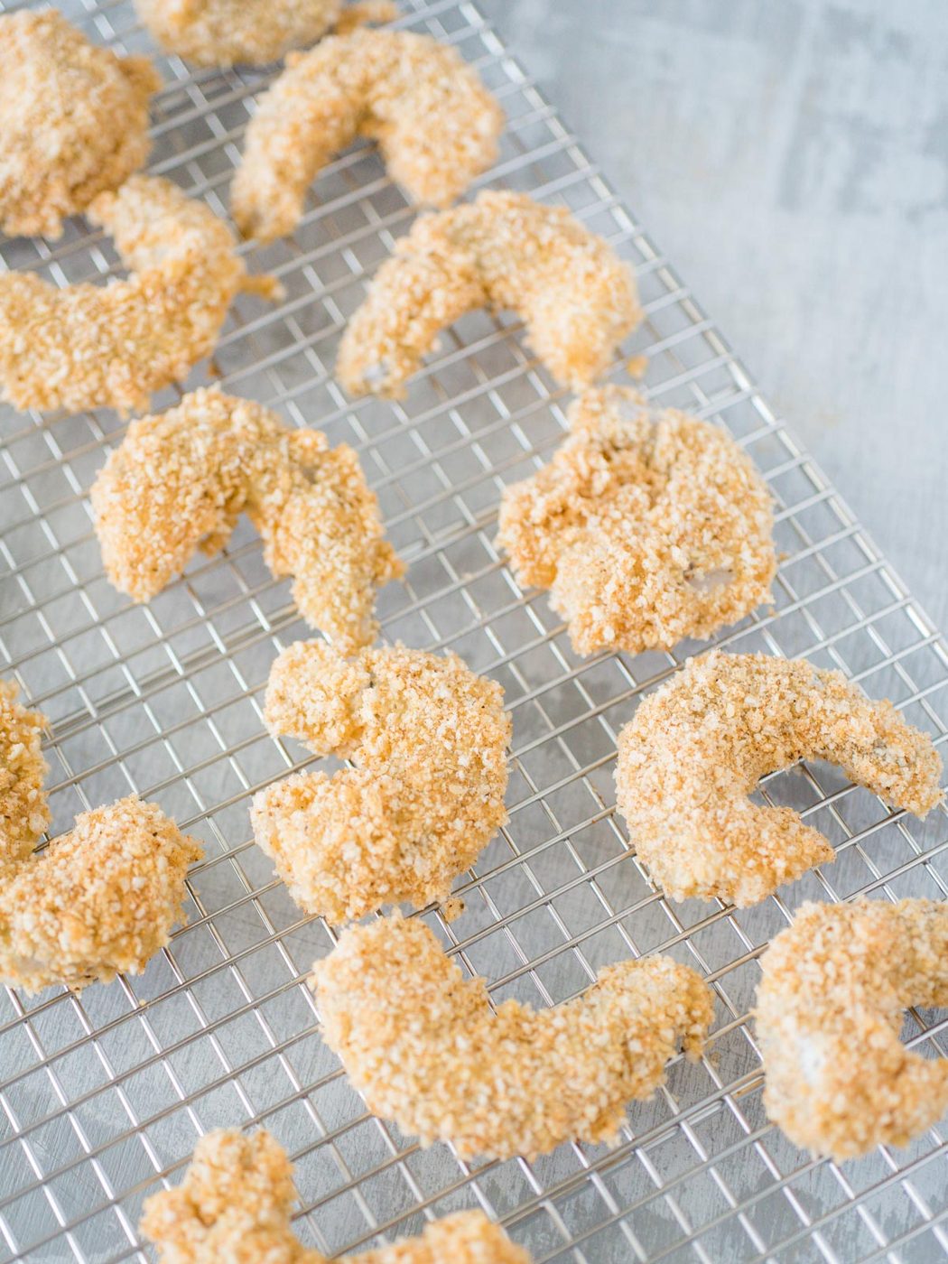 breaded shrimp on a cooling rack
