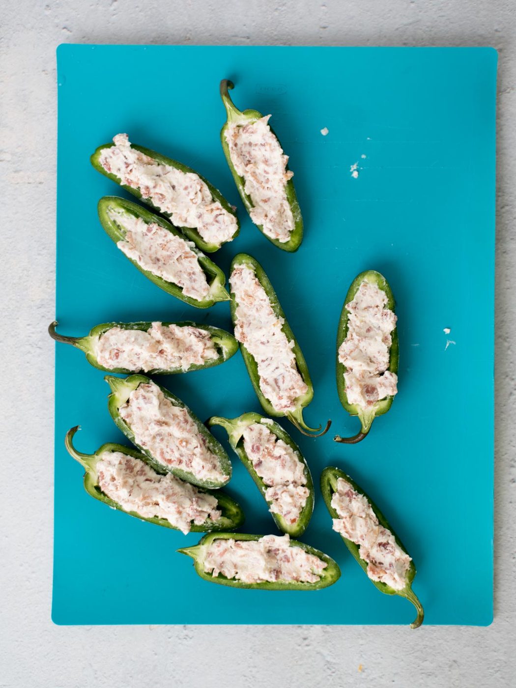 stuffed jalapenos on a cutting board