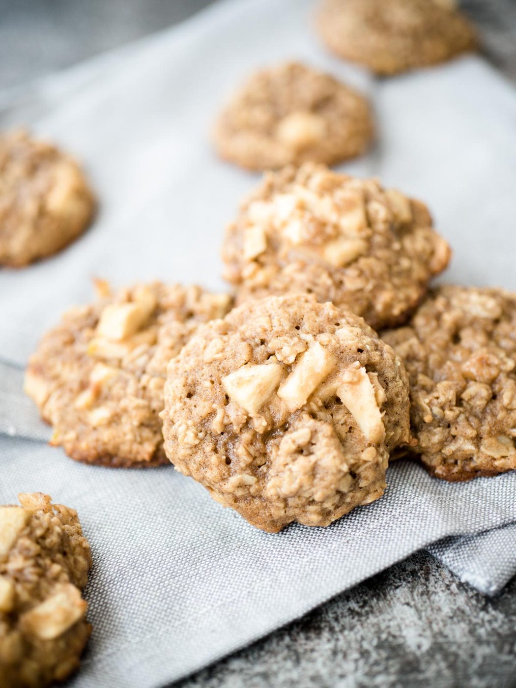 apple cinnamon oatmeal cookies on a grey cloth