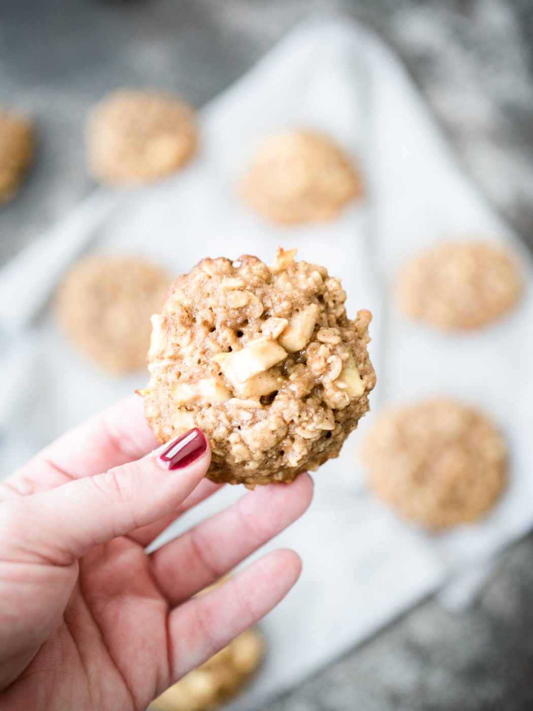 hand holding apple cinnamon oatmeal cookie