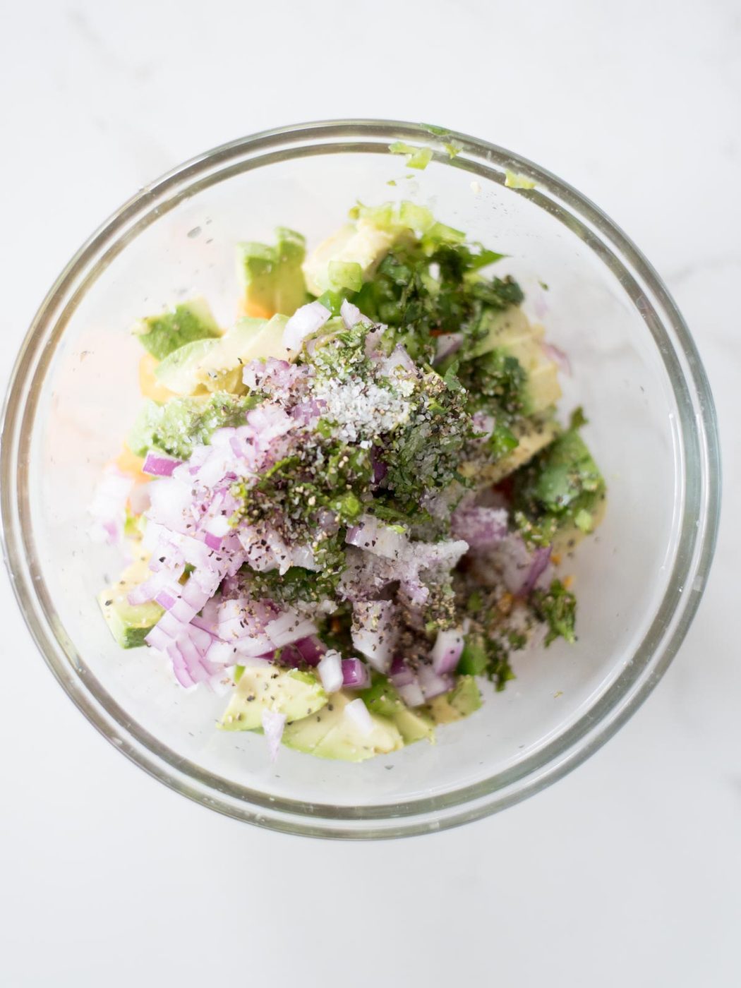 unmixed ingredients for avocado mango salsa in a mixing bowl