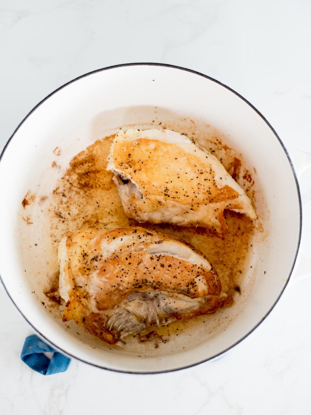seared chicken inside of a dutch oven