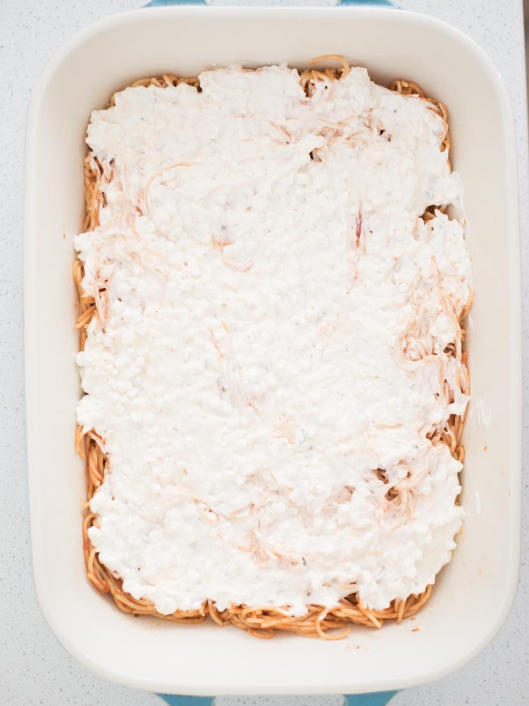 spaghetti noodle mix topped with cream cheese and cottage cheese mix