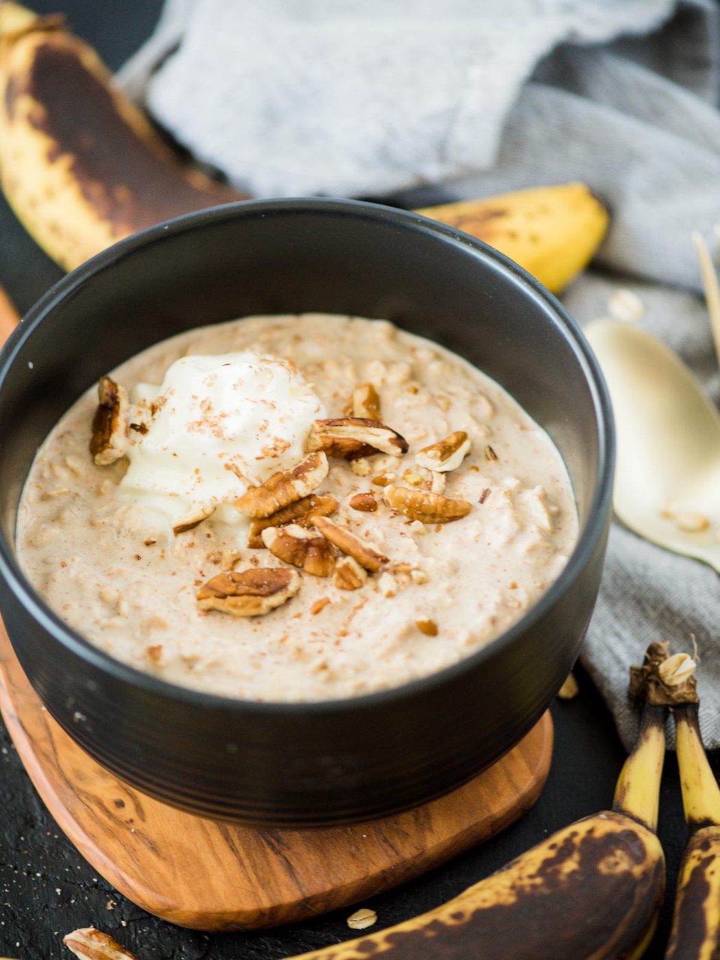 banana bread overnight oats in bowl topped with pecans and whipped cream