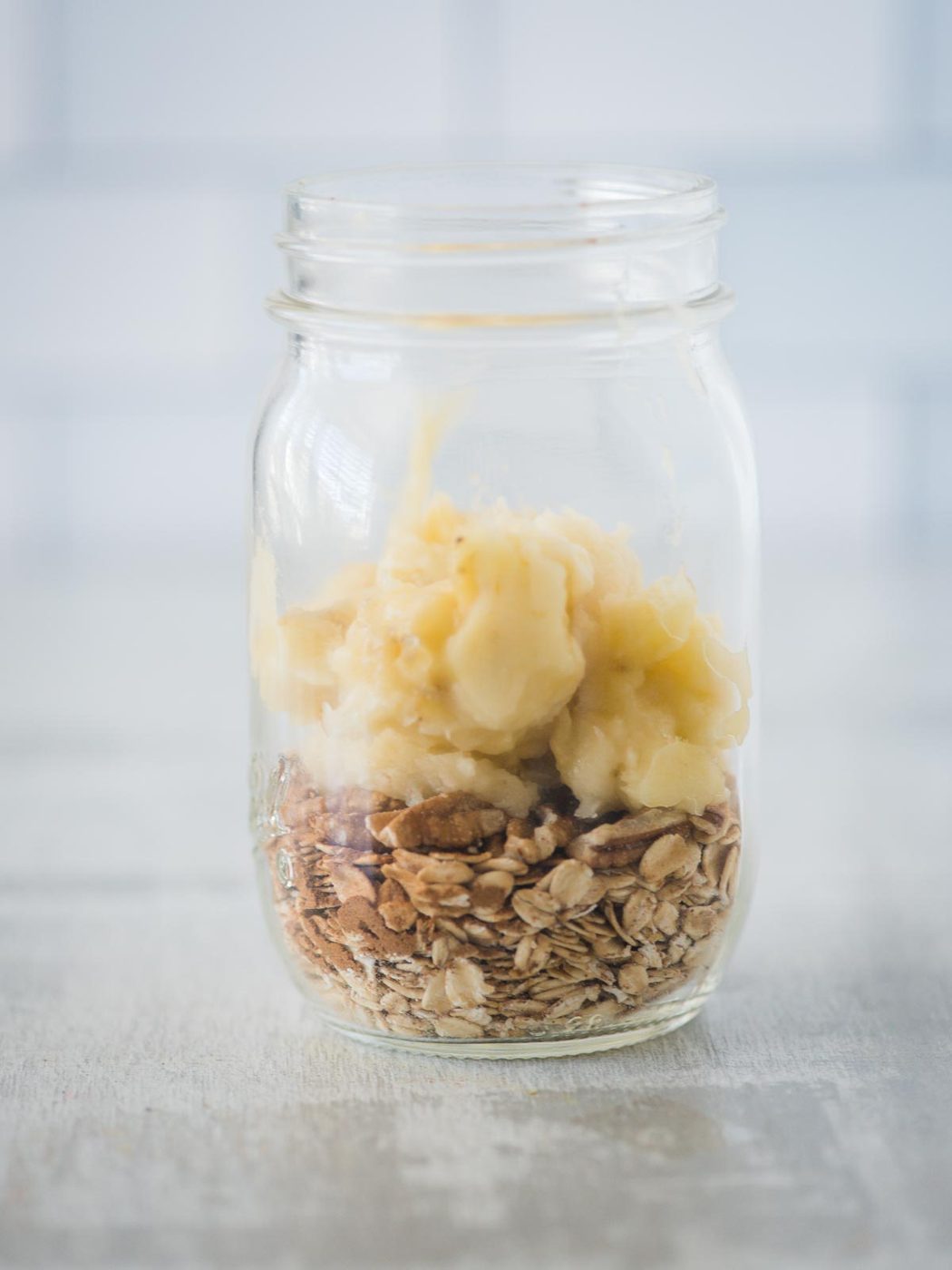 mashed banana added to jar of ingredients