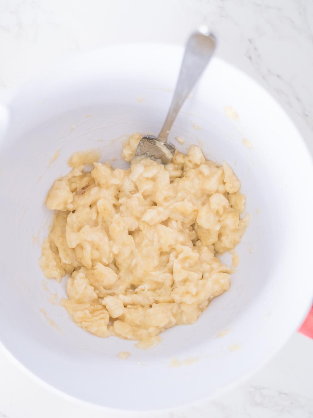 mashed bananas in a mixing bowl