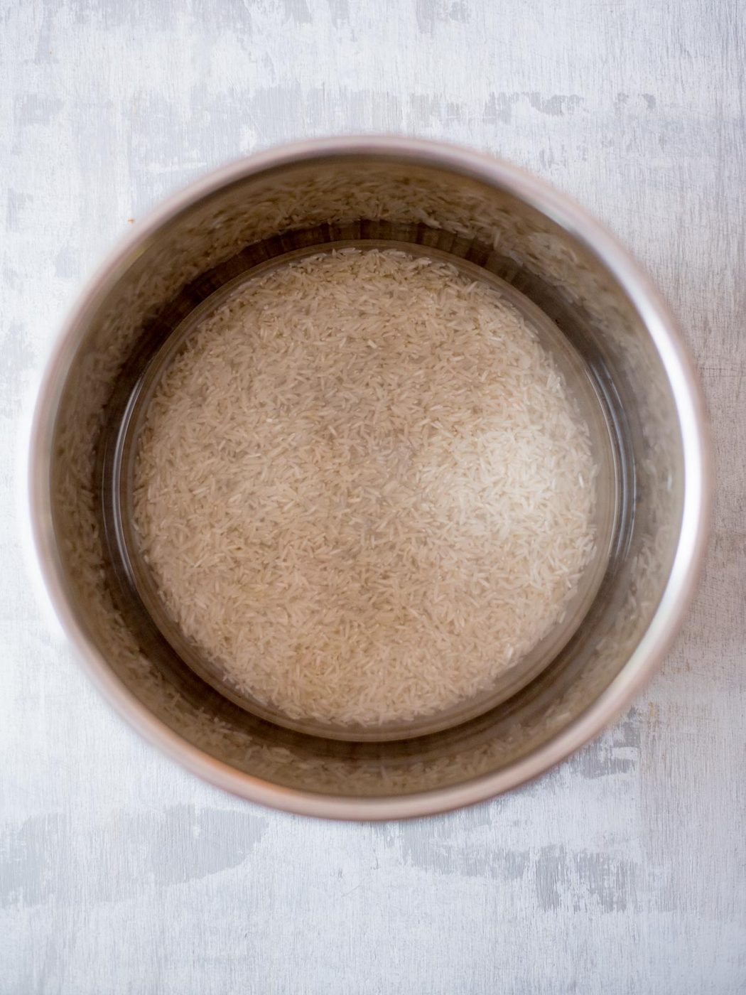 Water and uncooked basmati rice in the instant pot.