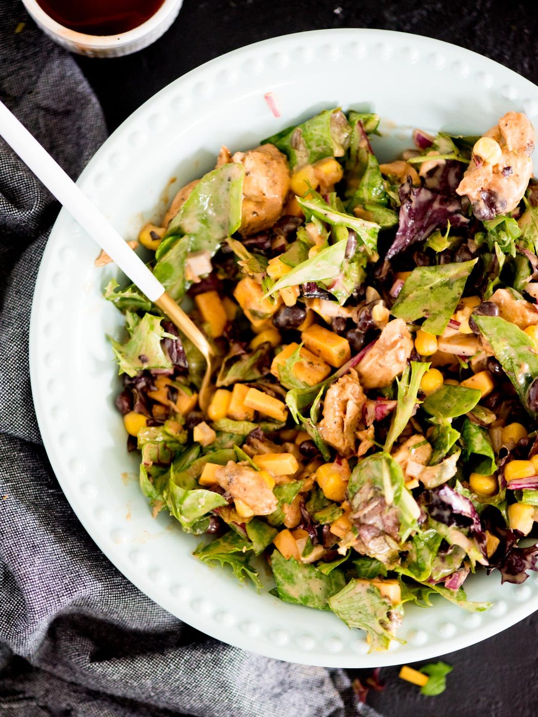 bbq chicken mason jar salad poured into a blue bowl
