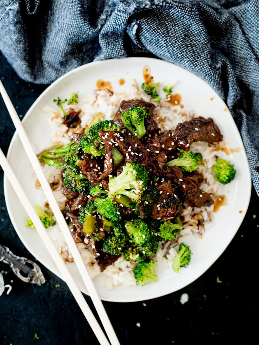 Chinese beef and broccoli served over rice topped with sesame seeds