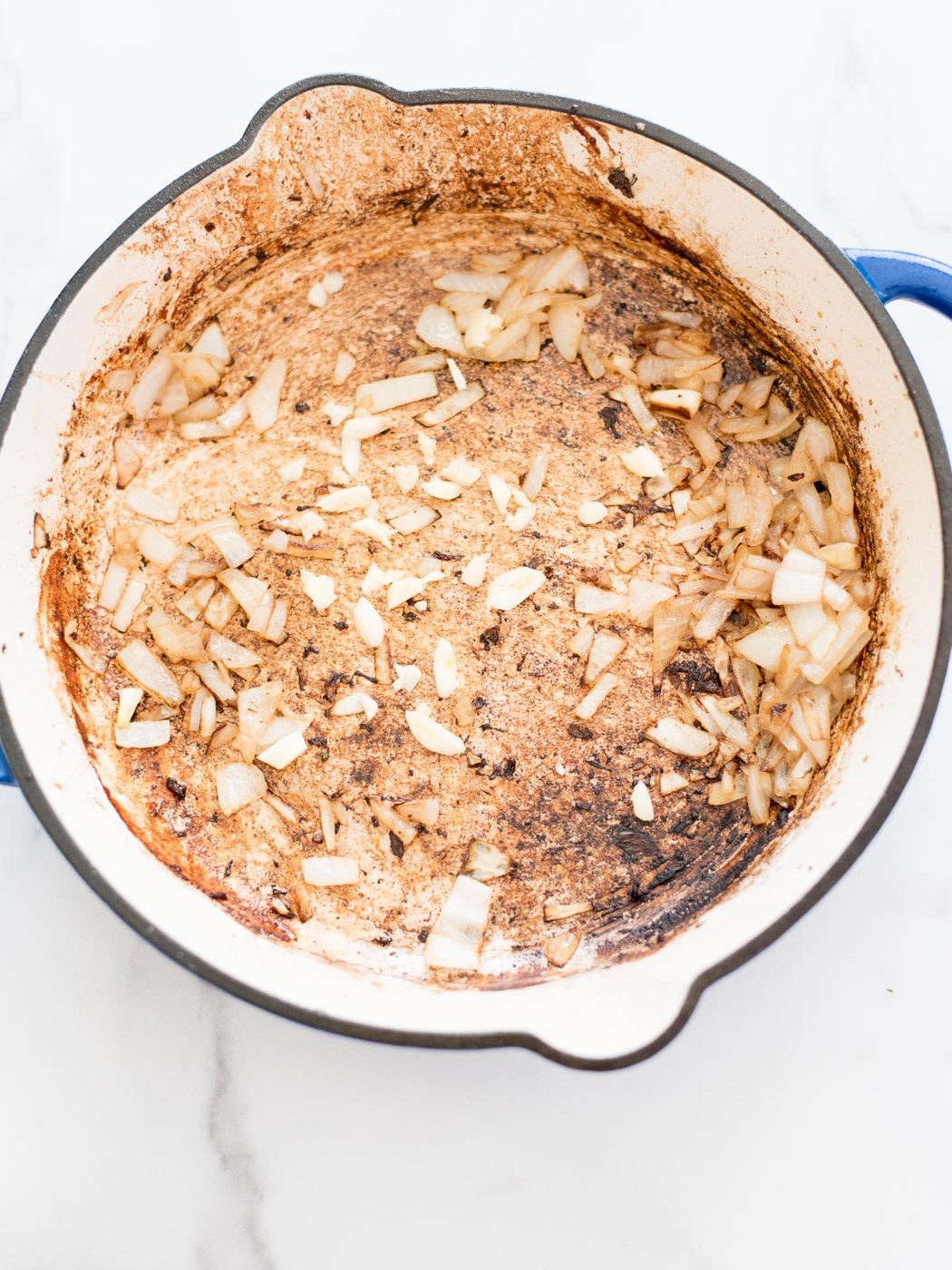 garlic and onion sautéing in a skillet