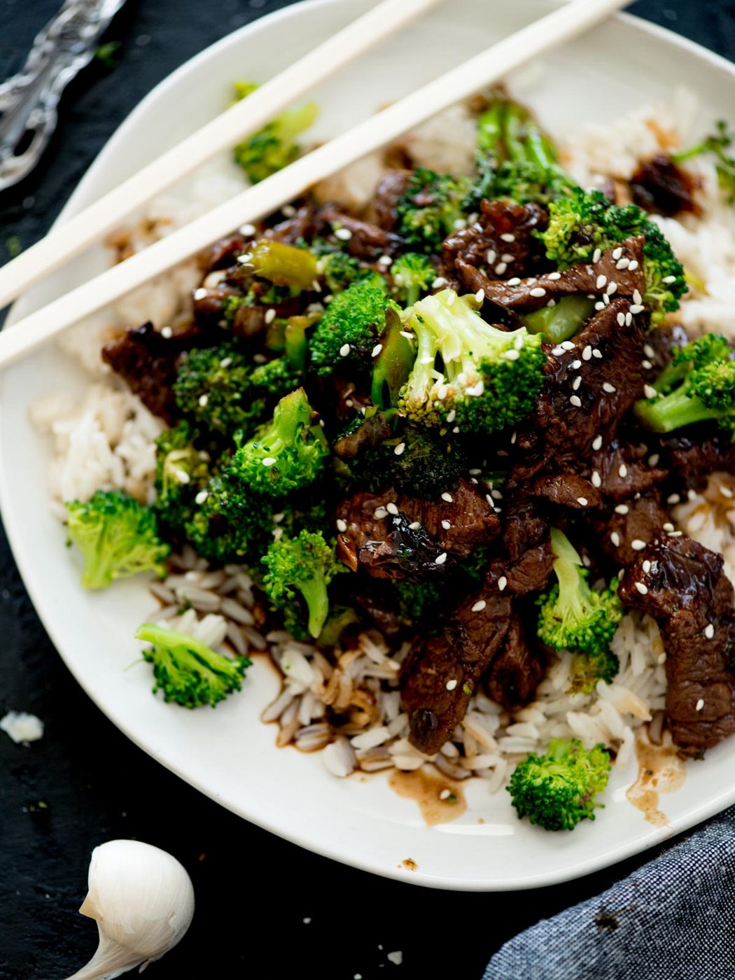 Chinese beef and broccoli served over rice topped with sesame seeds