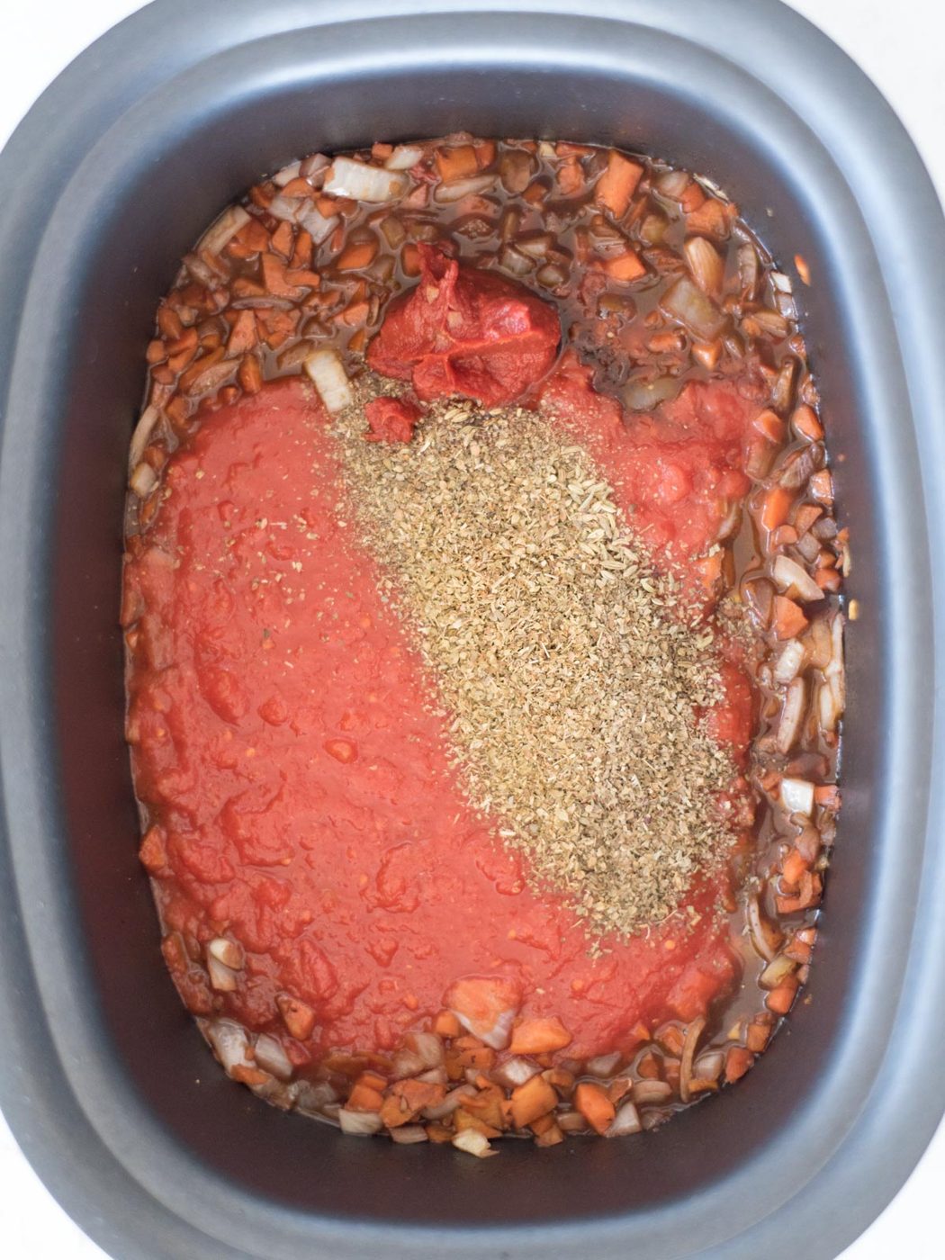 crushed tomatoes and herbs poured over vegetables
