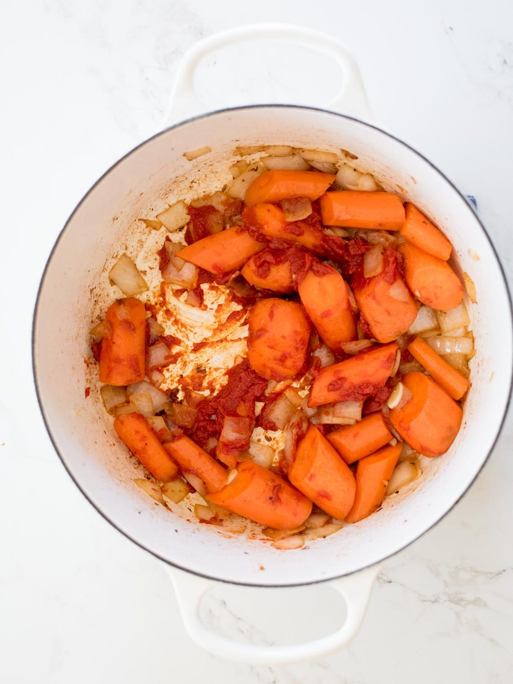 vegetables and tomato paste caramelized in a Dutch oven