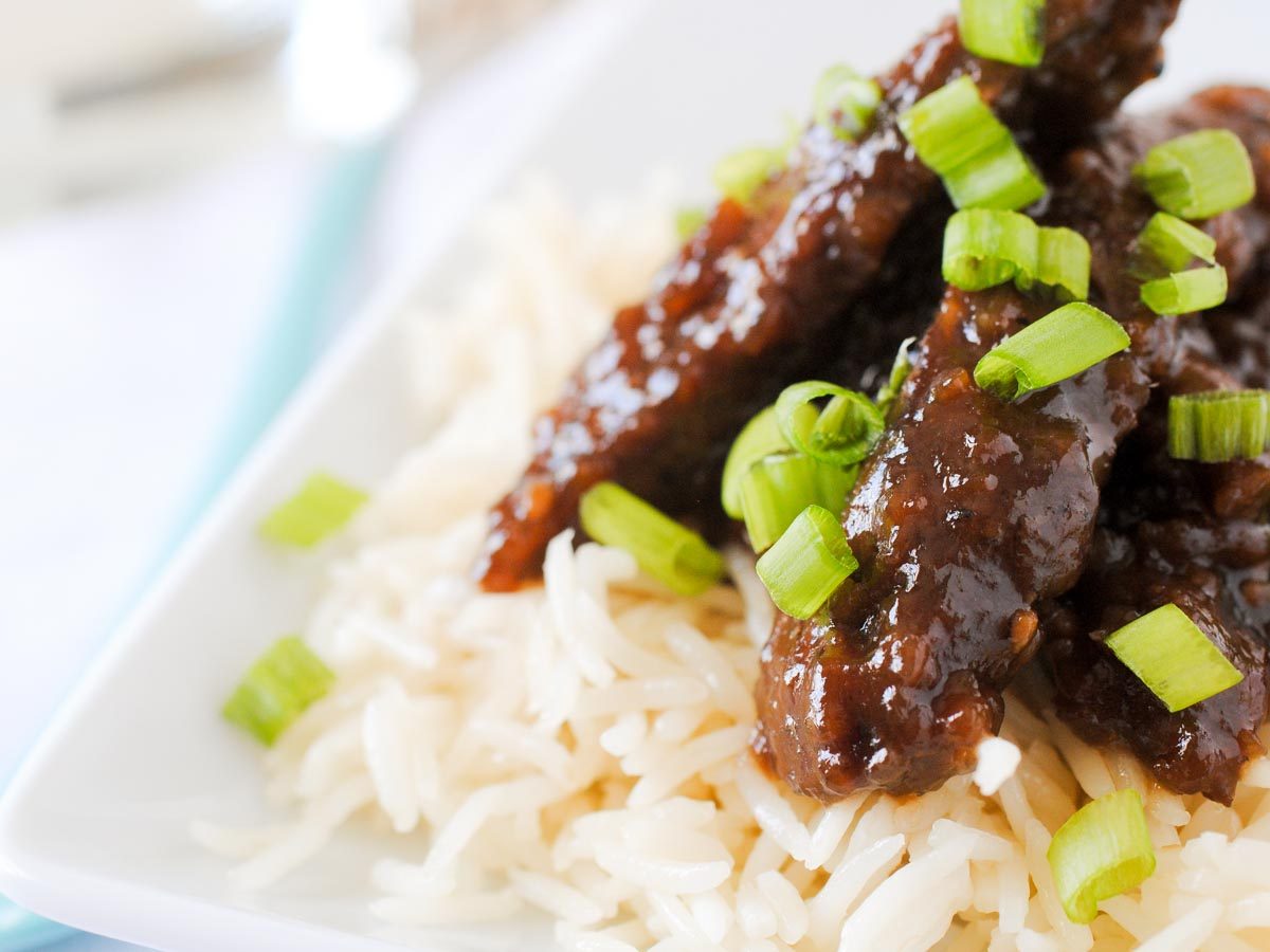 beef teriyaki on rice topped with green onion