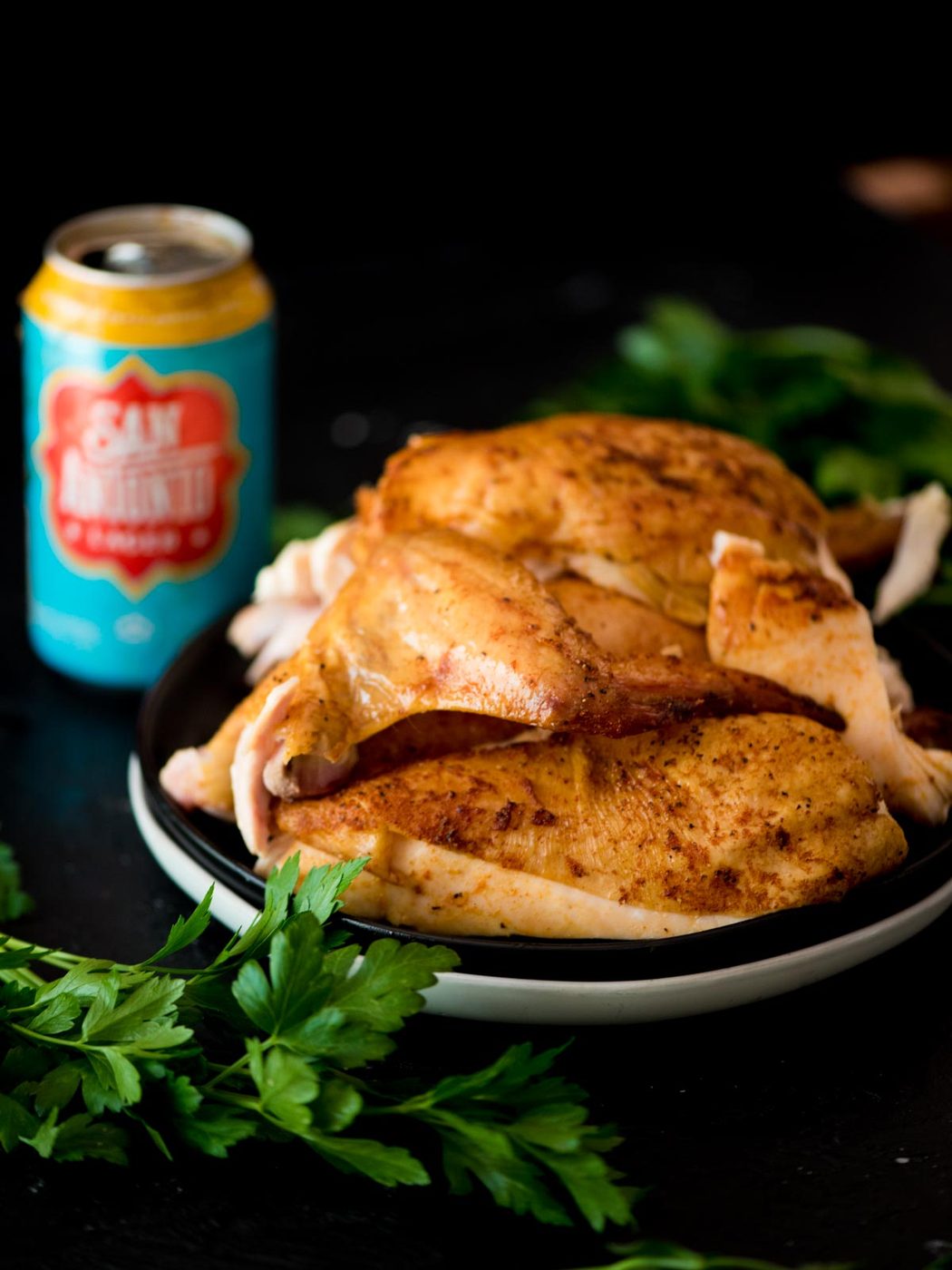 pit boss beer can chicken on a plate with a beer