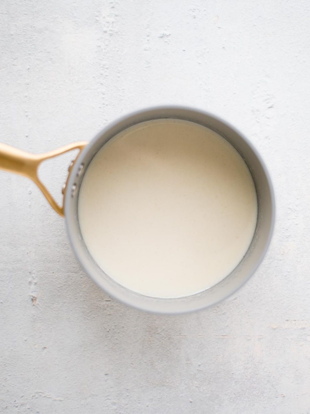 roux with milk and beer in a saucepan