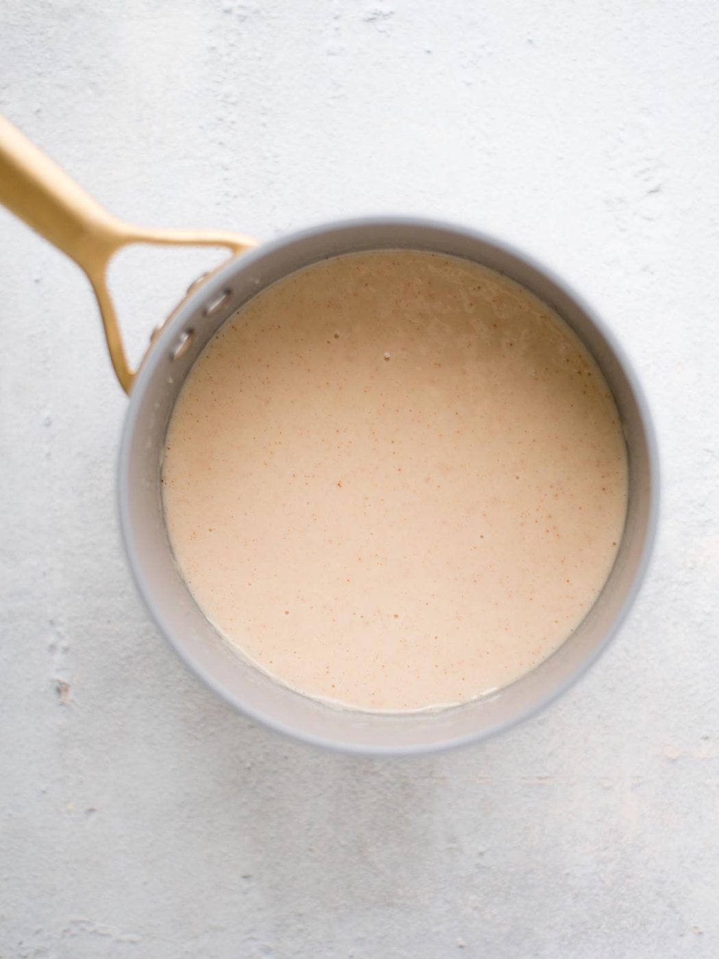 seasoned milk and roux in a saucepan
