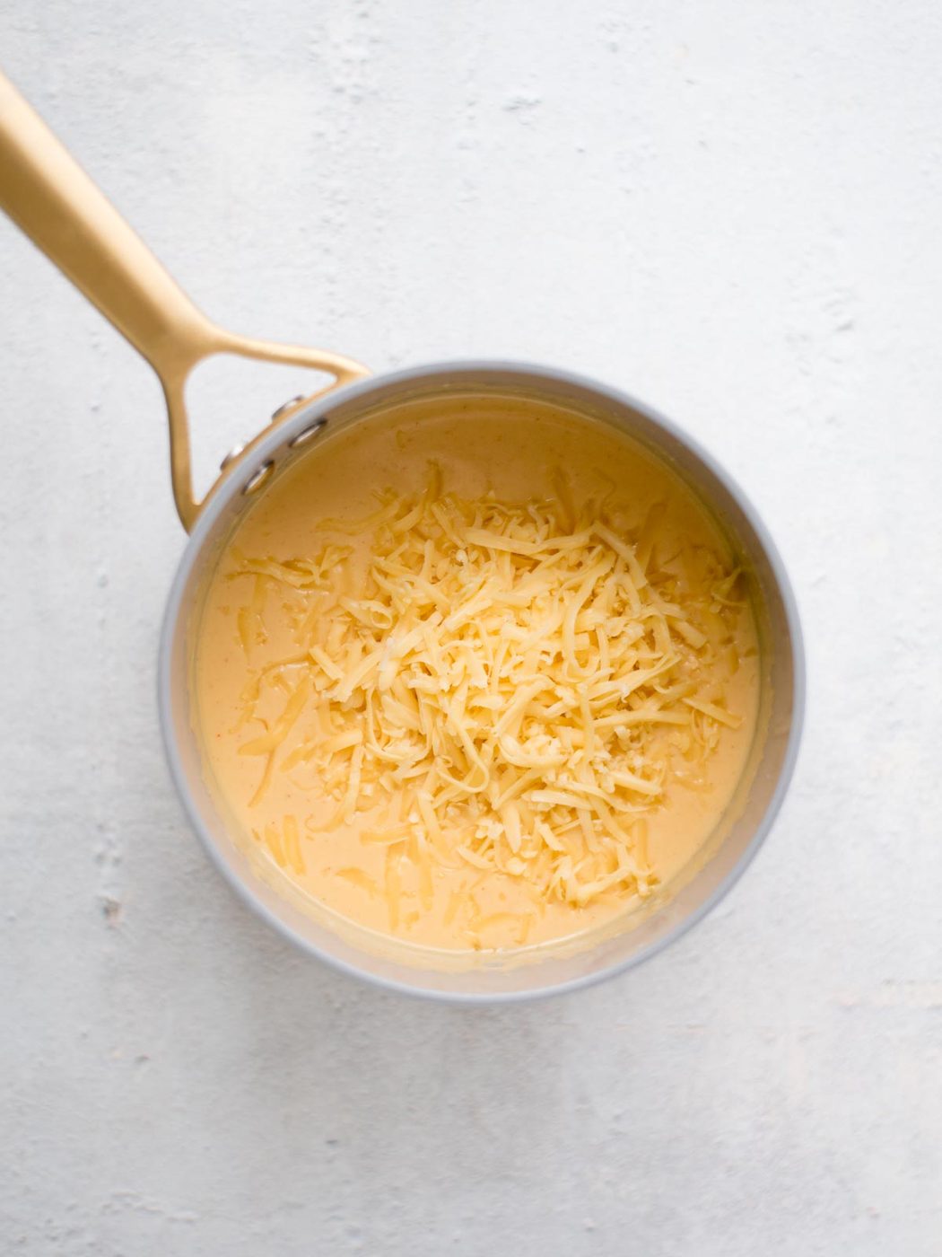 shredded gouda added to the saucepan