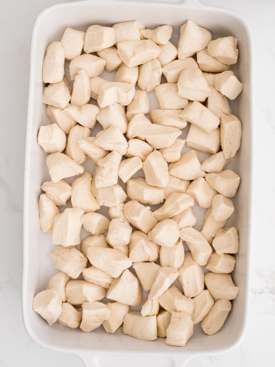 cut biscuits in a casserole dish