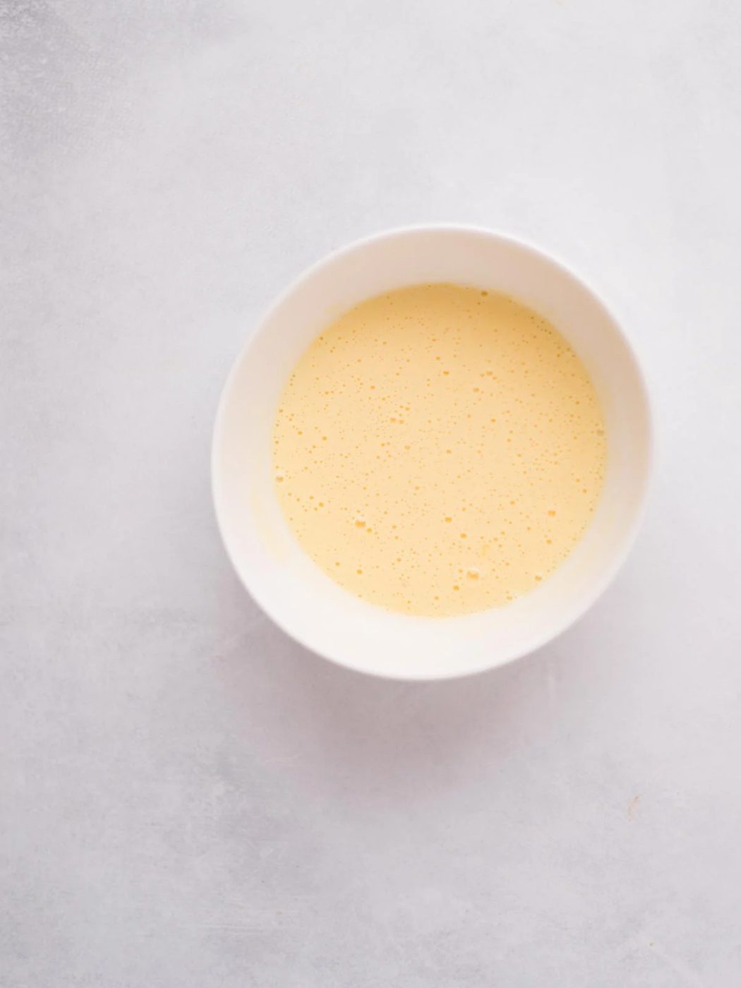 beaten egg in a bowl.