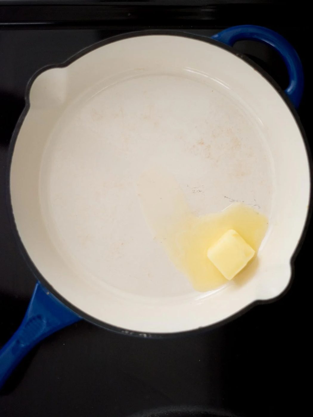 butter melting in a skillet on the stove