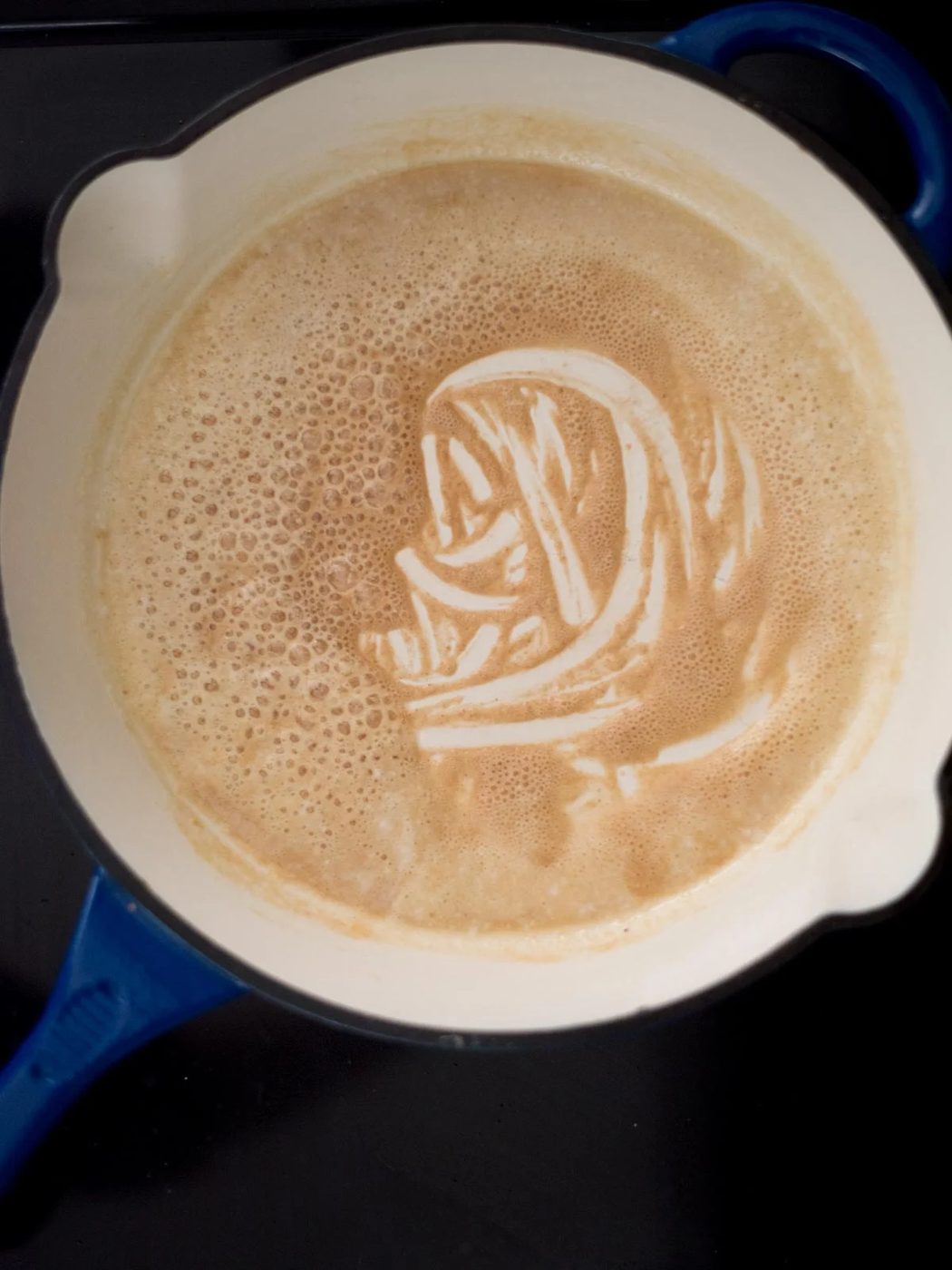 roux made from butter and flour browning on the stove