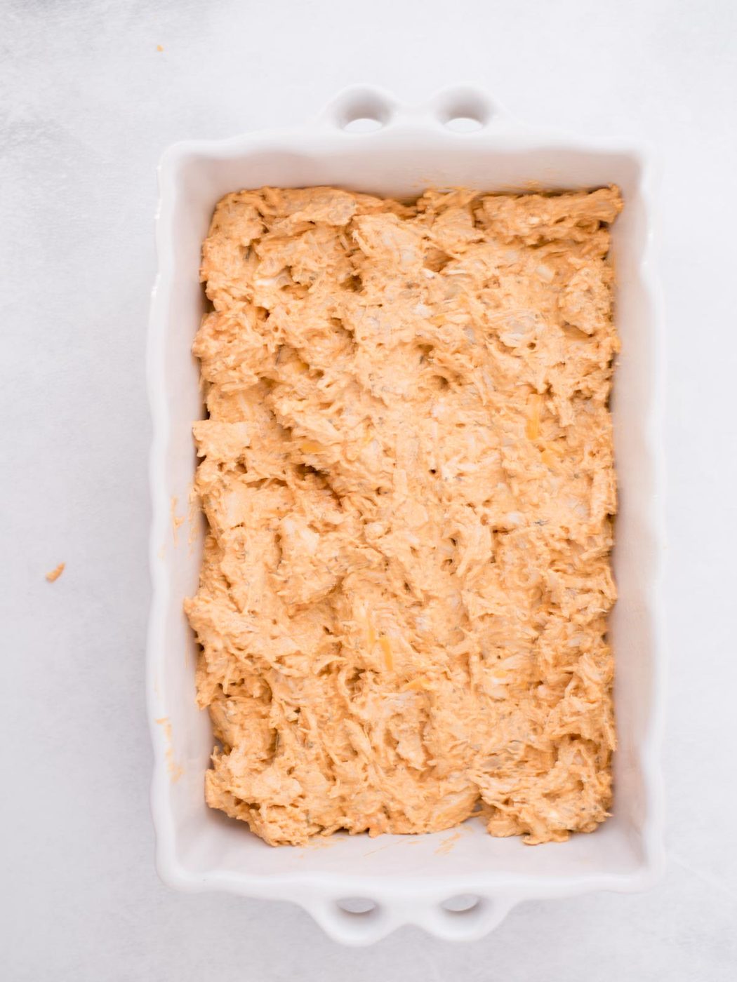 Chicken mixture added to a baking dish.