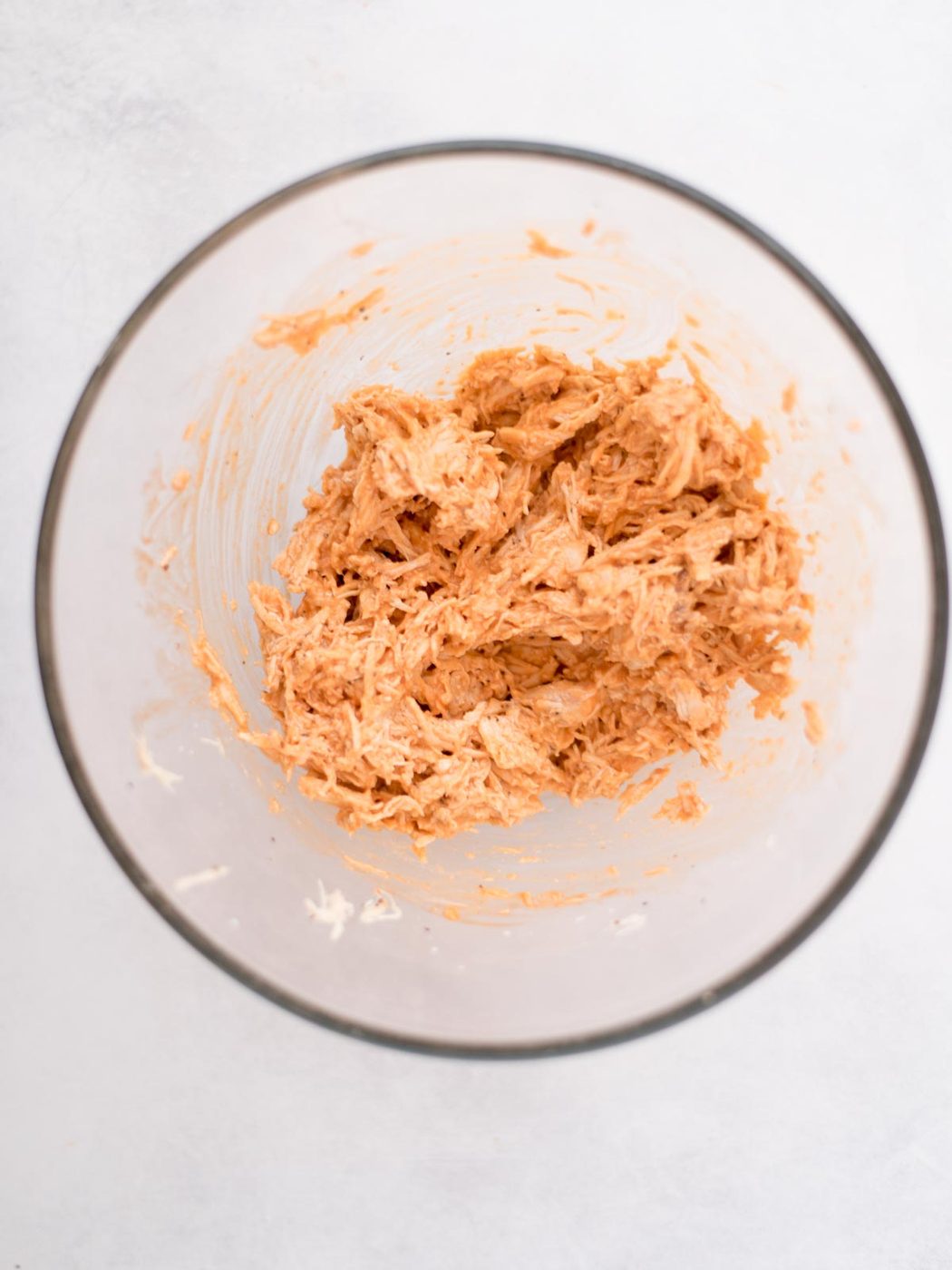 Mixing bowl with buffalo chicken mixture.