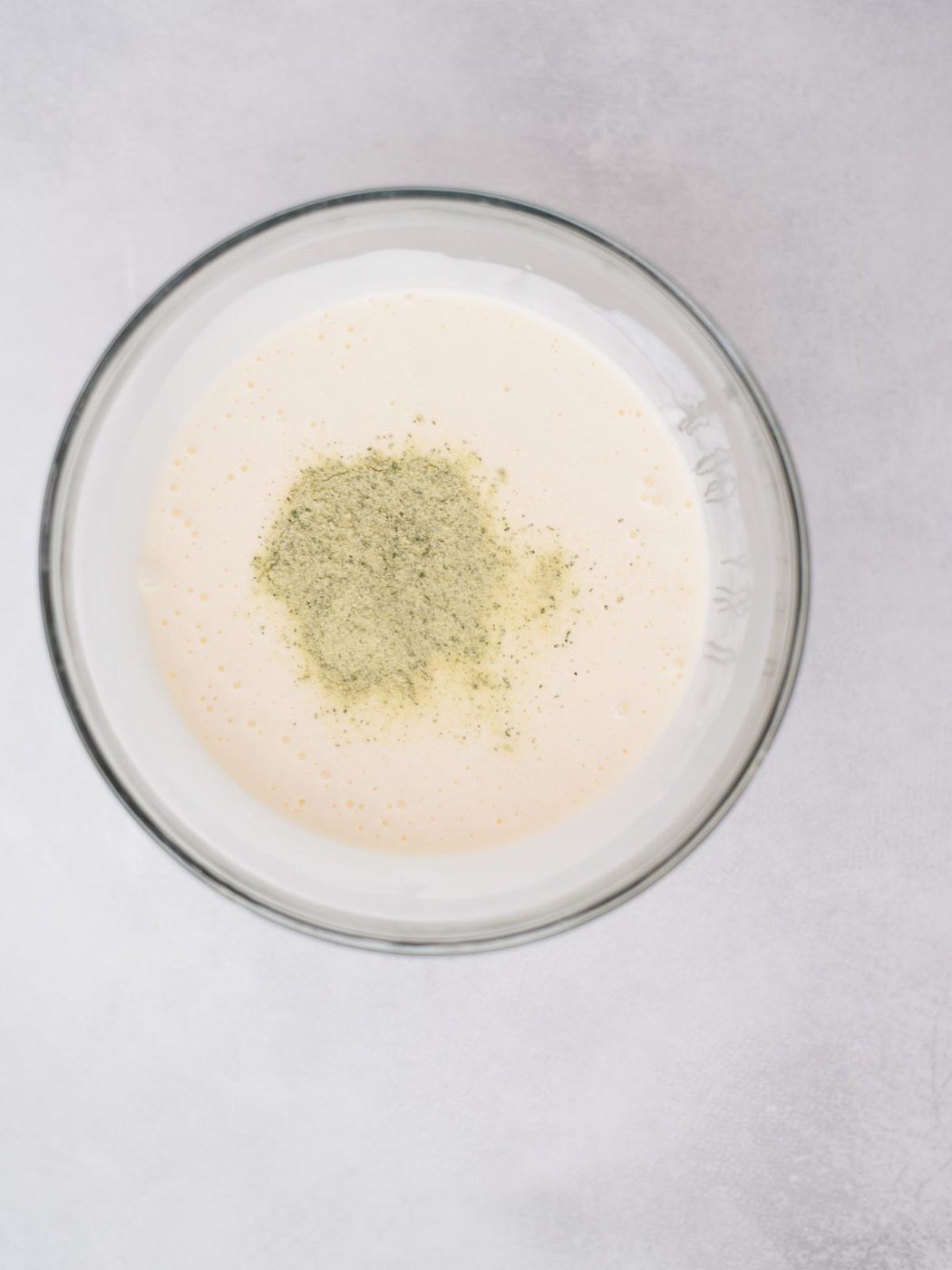 Dry ranch seasoning added to the mayo mixture in a bowl.