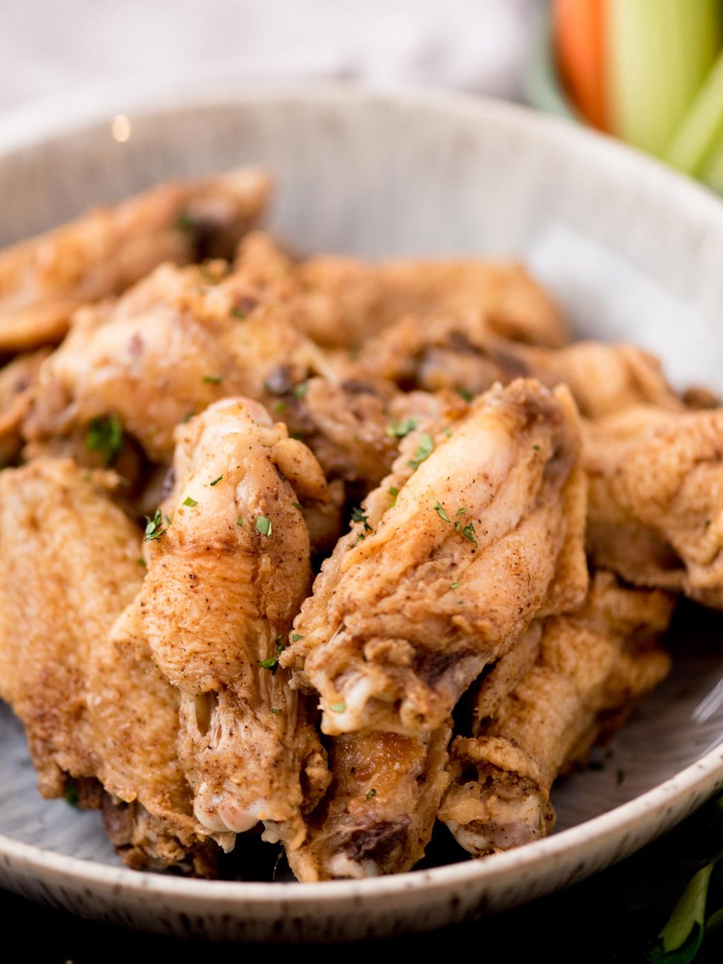 Close up to a bowl filled with cajun chicken wings.