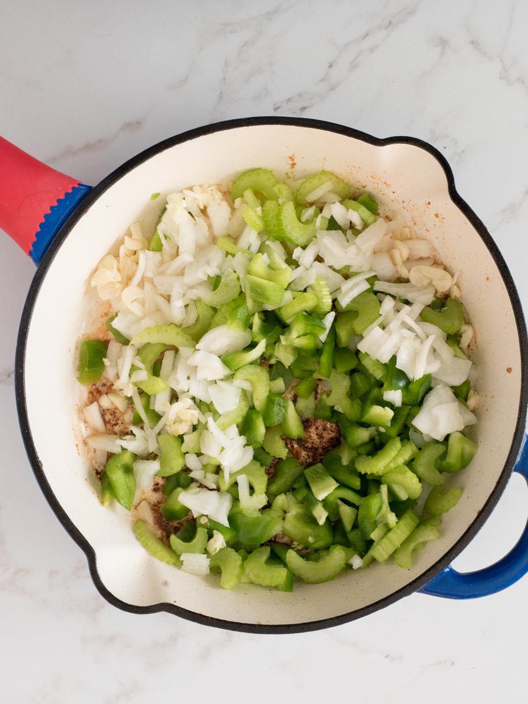 raw vegetables added to a skillet