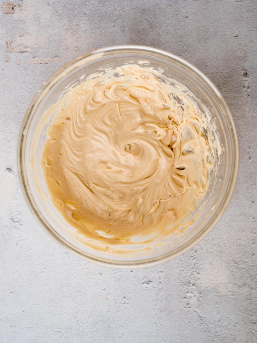 cream cheese layer of caramel apple dip mixed together in a bowl