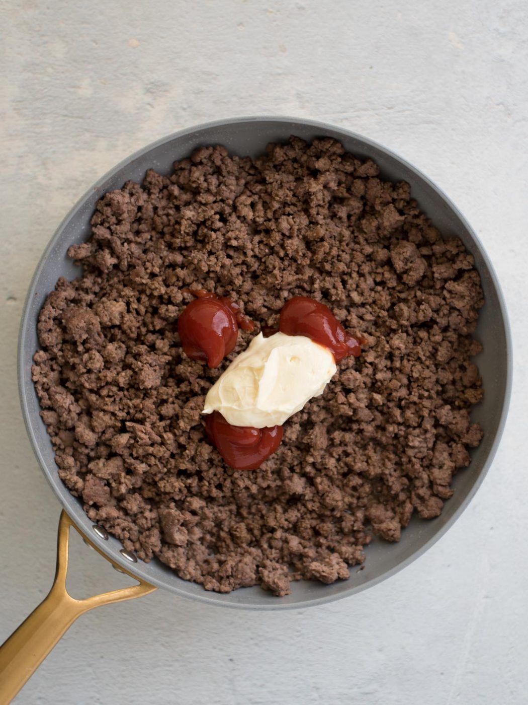 ground beef mixture topped with ketchup and mayo
