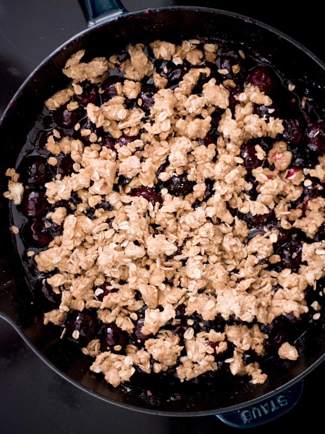 crisp topping on cherries in a cast iron skillet
