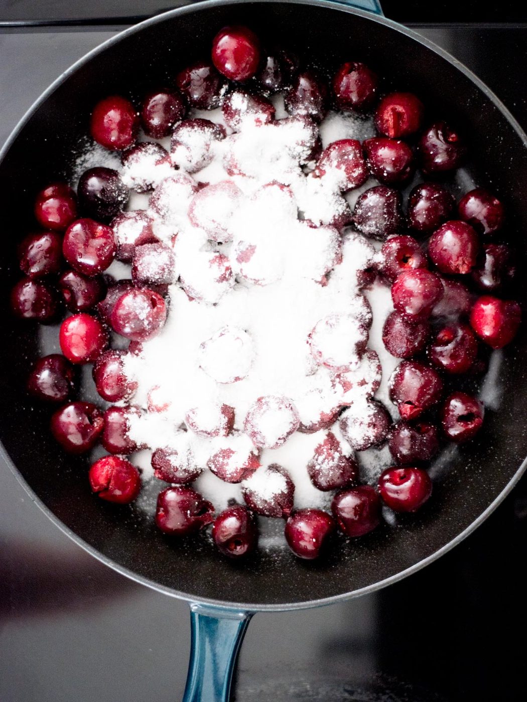 cherries, cornstarch, and sugar in a cast iron skillet on the stove