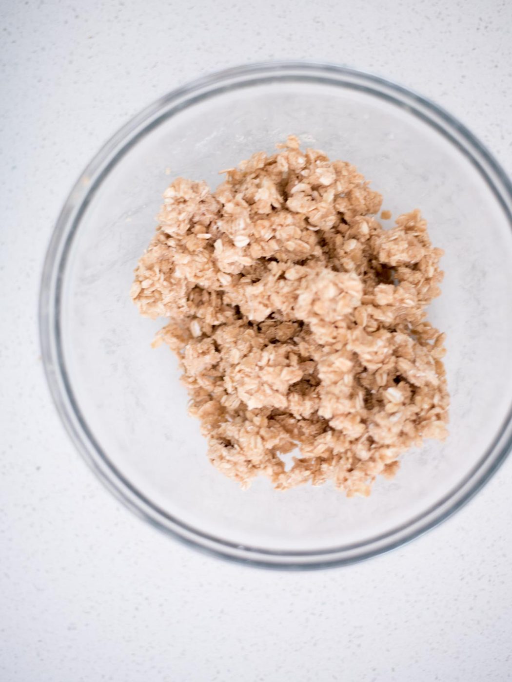 crisp topping ingredients mixed together in a glass bowl