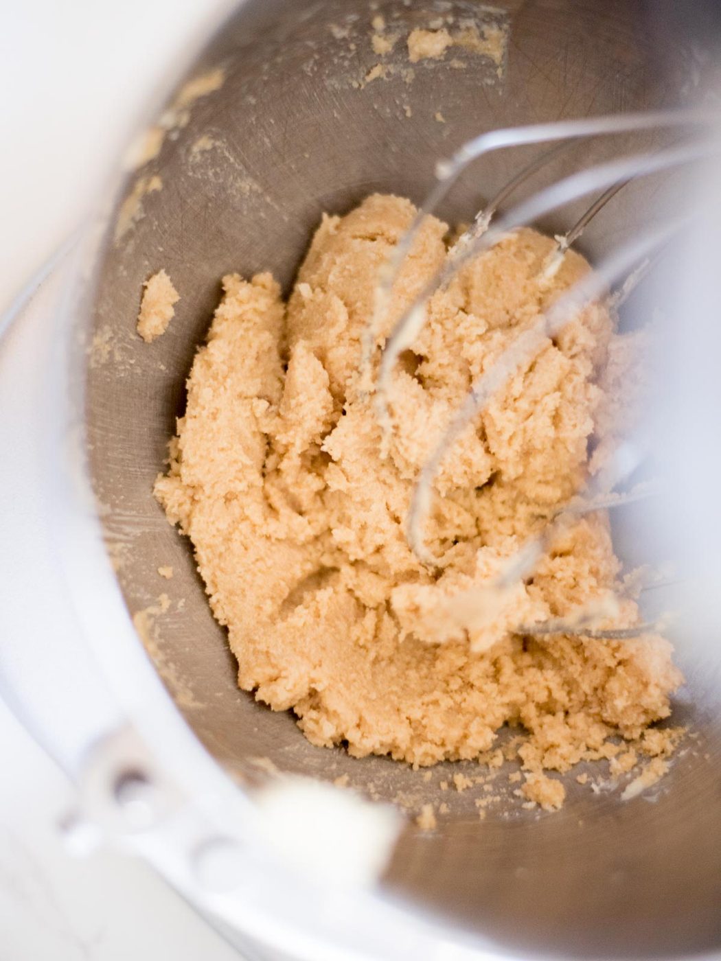 butter, brown sugar, and white sugar creamed together in a metal mixing bowl