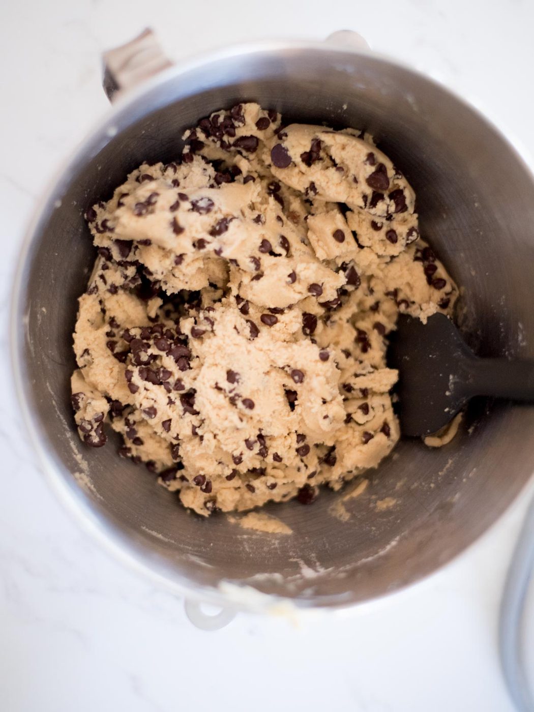 dough for a house favorite chewy chocolate chip cookies in a metal mixing bowl
