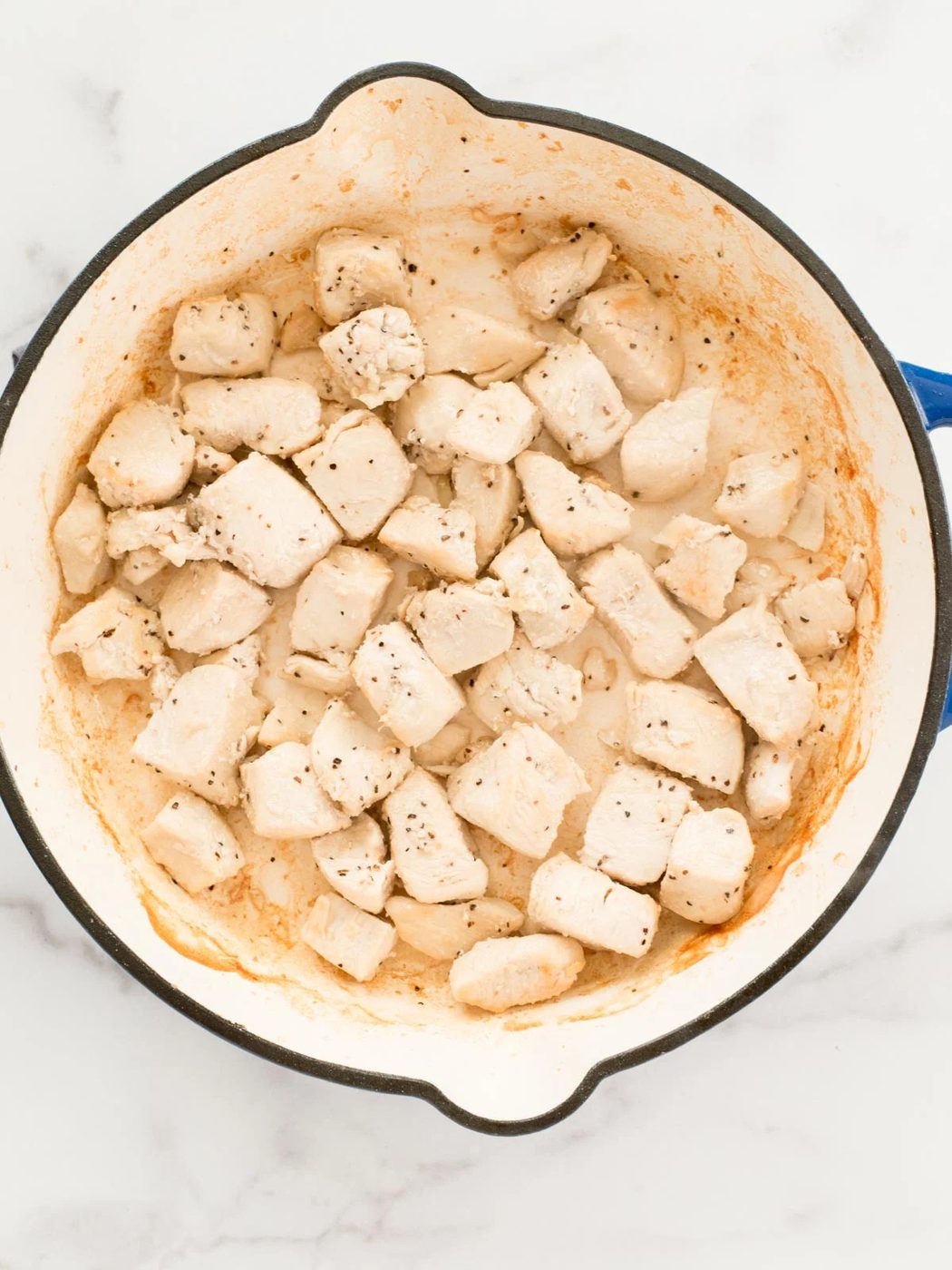 chicken searing in a skillet
