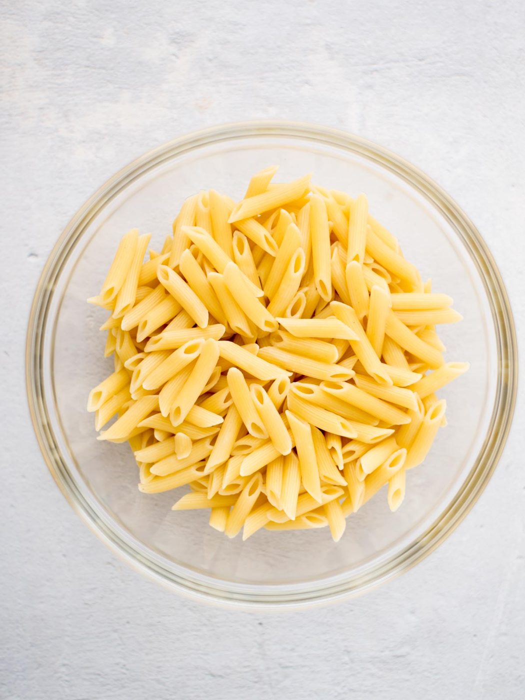 Cooked pasta in a mixing bowl.