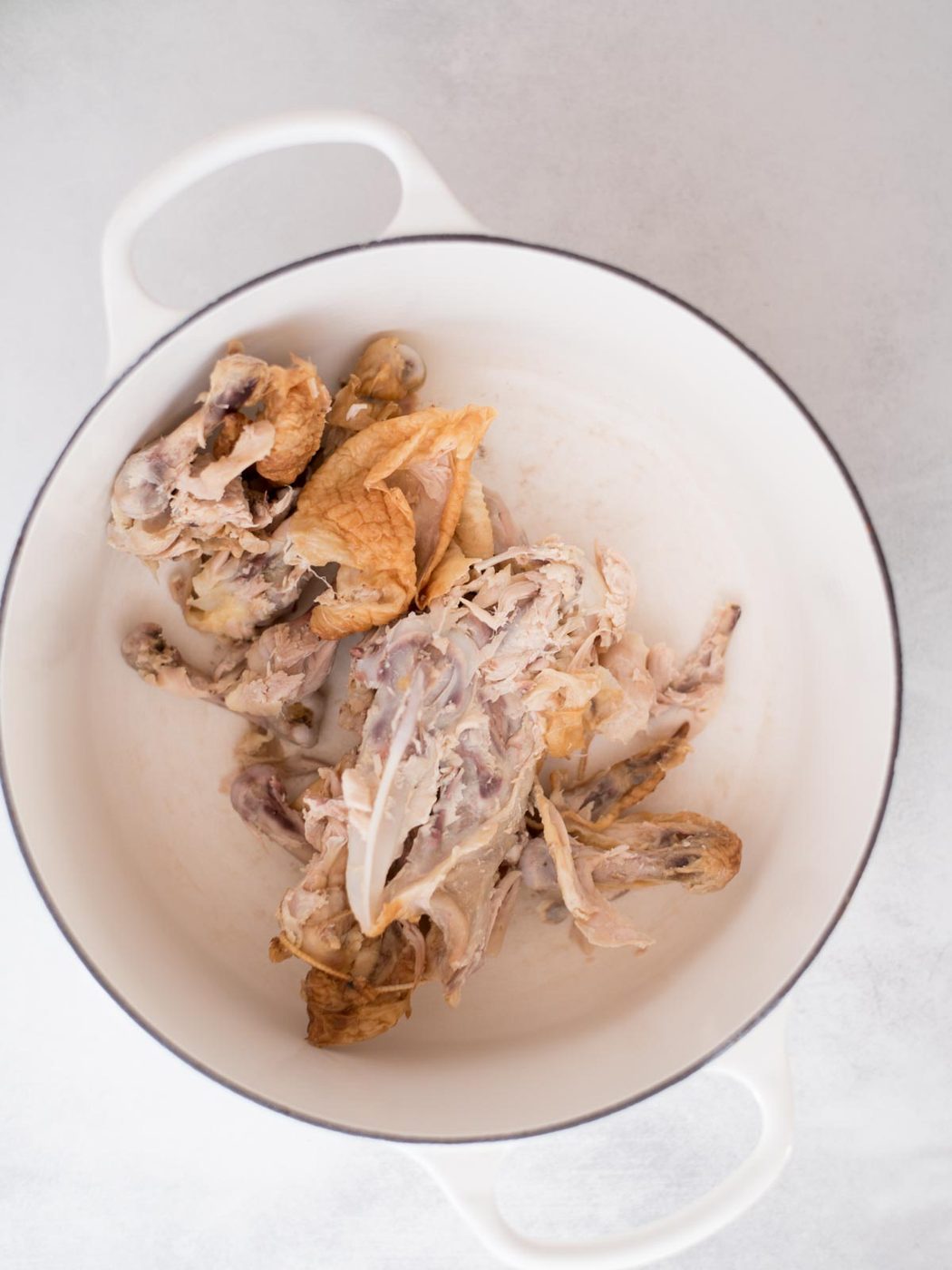 rotisserie chicken scraps in a dutch oven