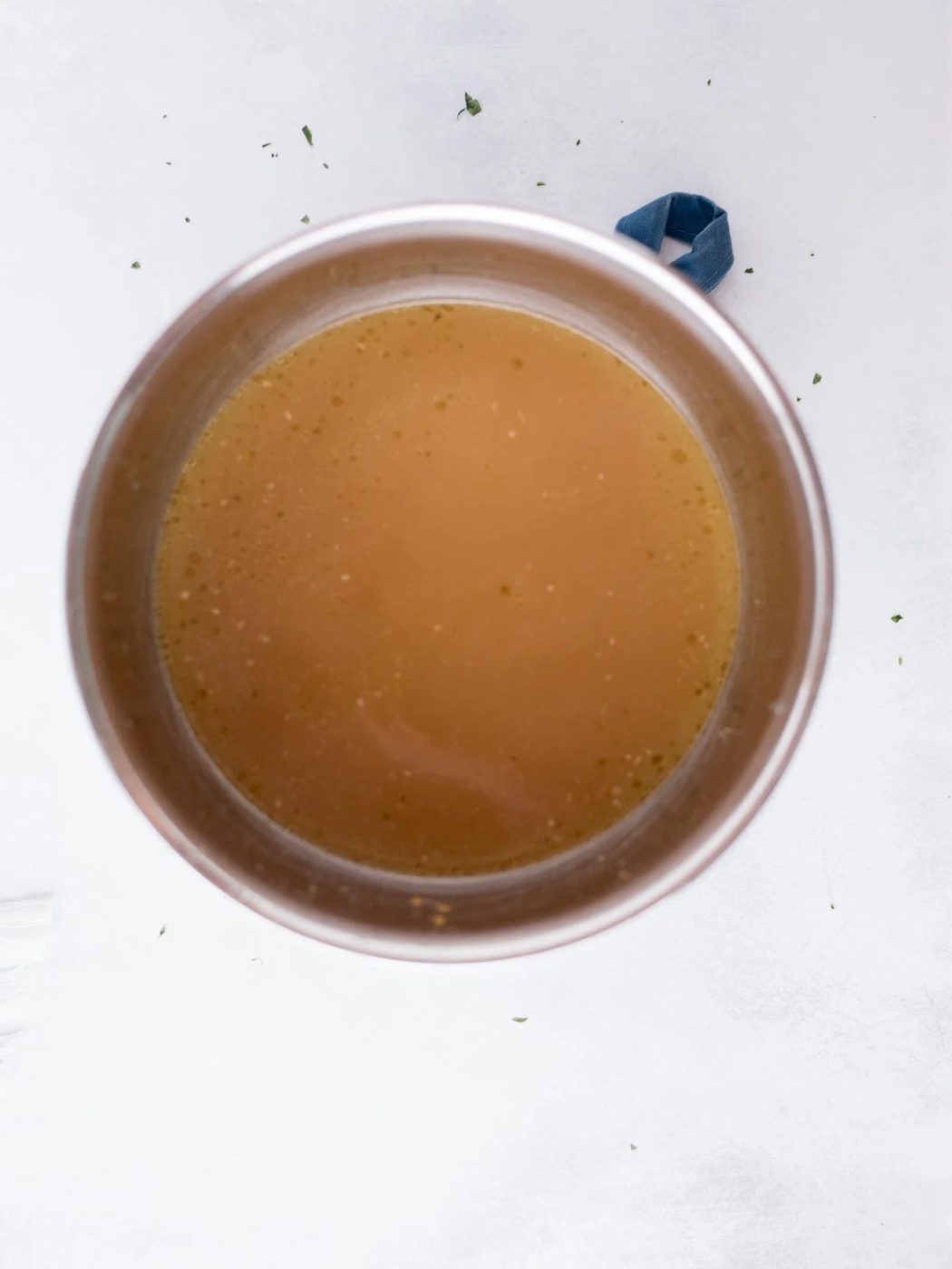 strained chicken broth in a mixing bowl