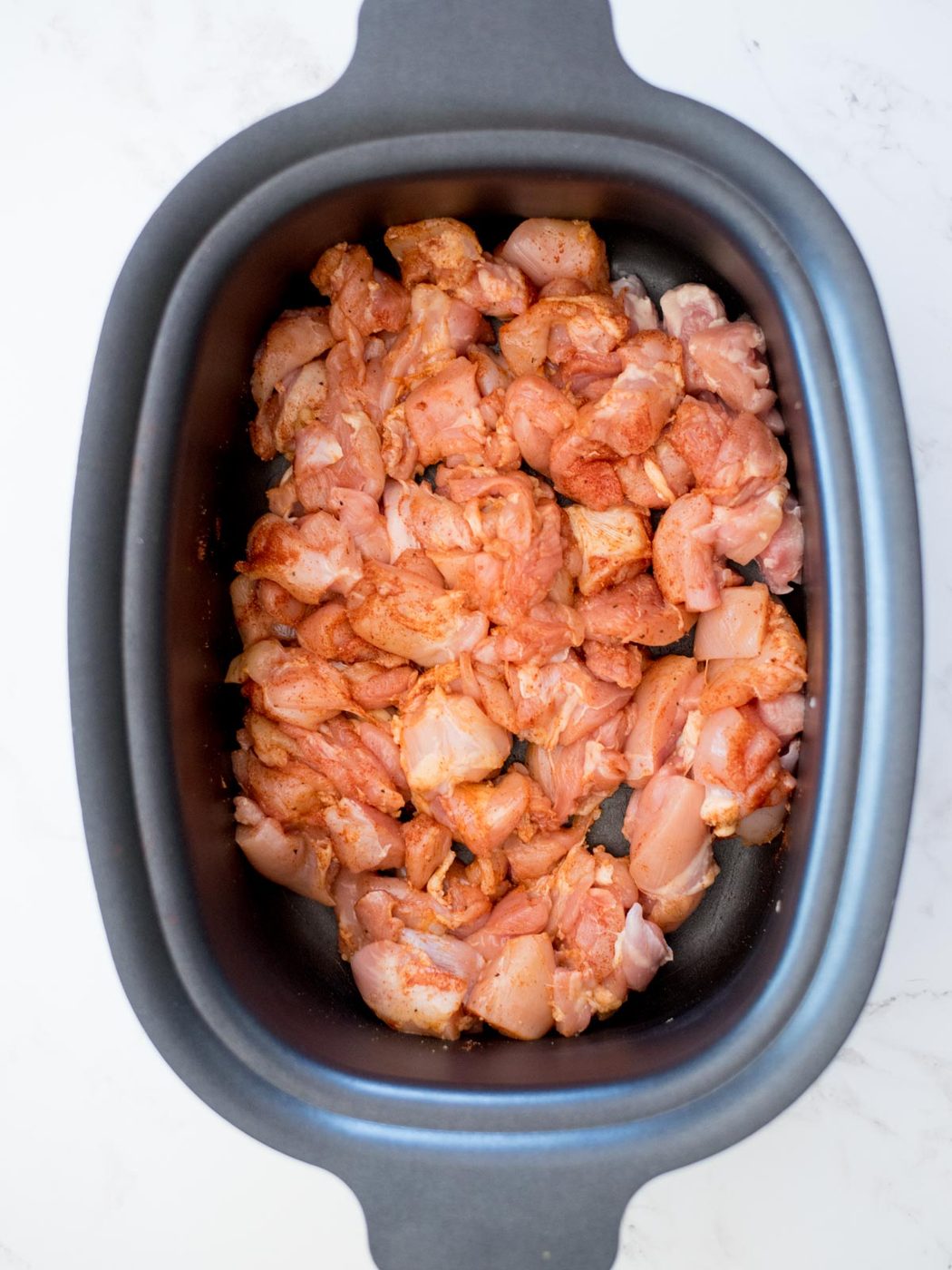chicken and seasoning in a crockpot for chicken chili