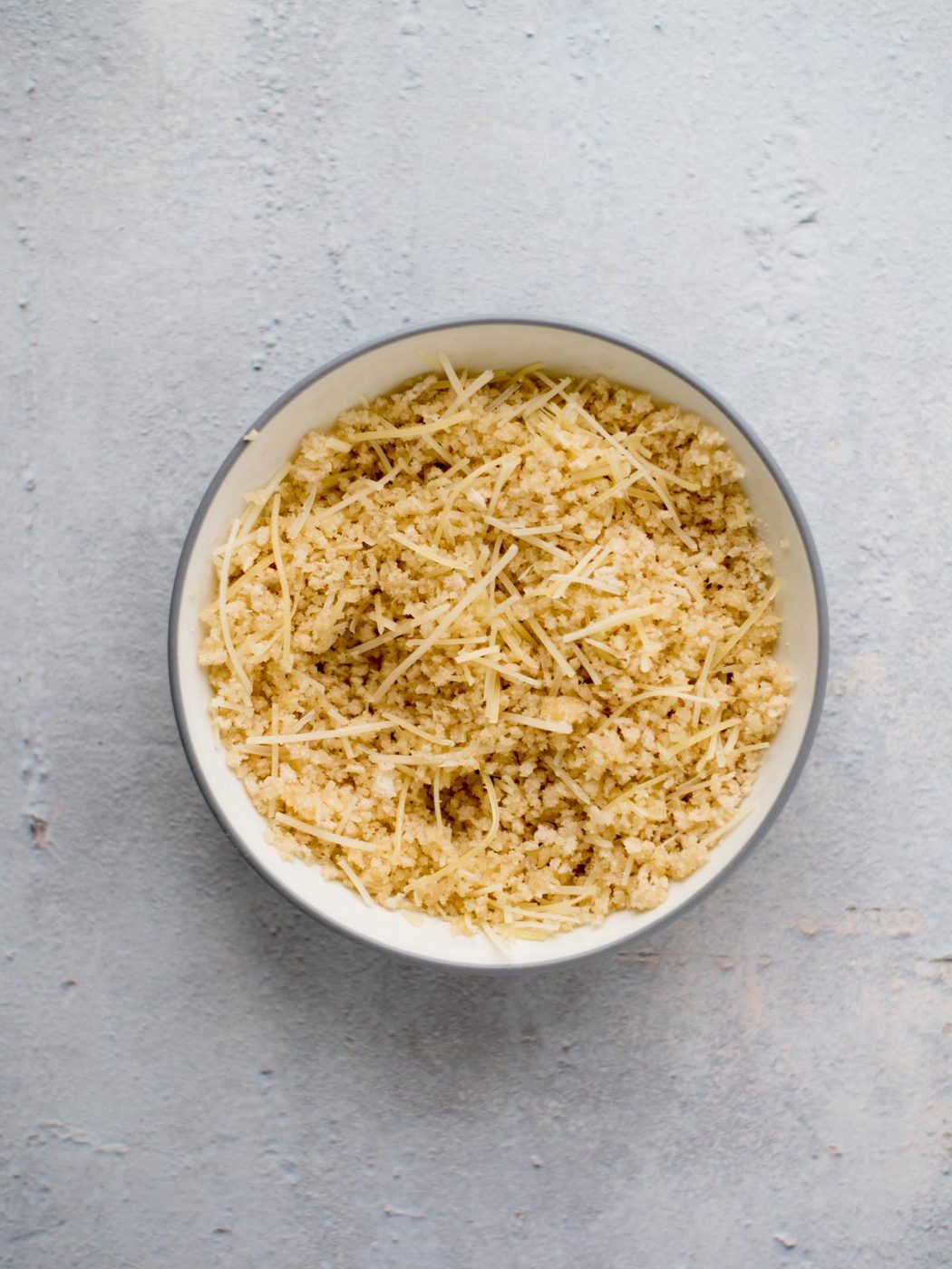 melted butter, breadcrumbs, and parmesan mixed together in a bowl