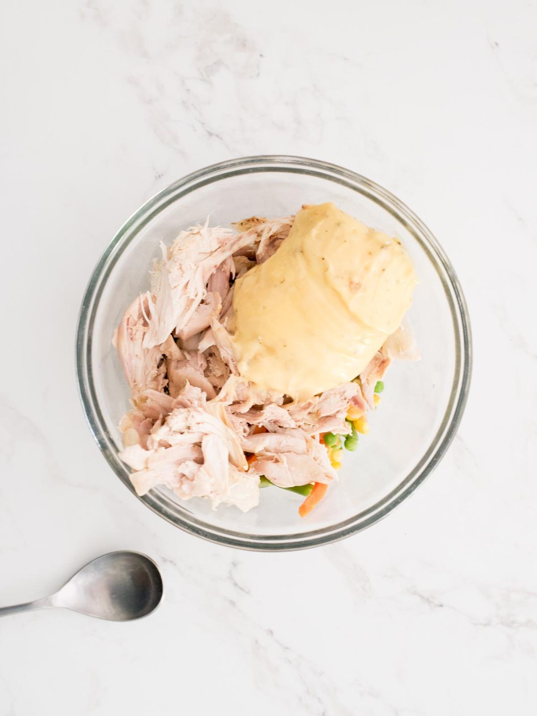 cream of chicken, vegetables, and chicken in a mixing bowl