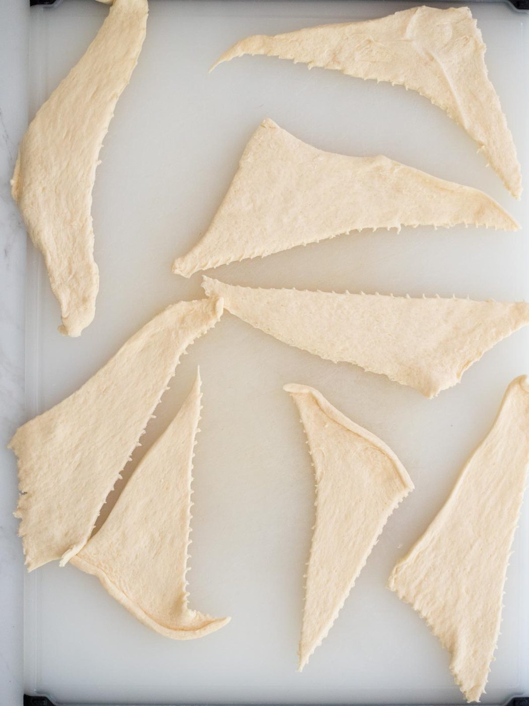 crescent roll dough separated on a cutting board