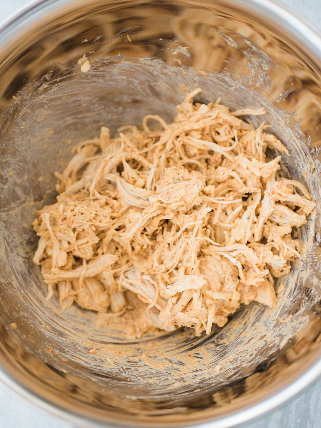 bowl full of chicken mixture for taquitos