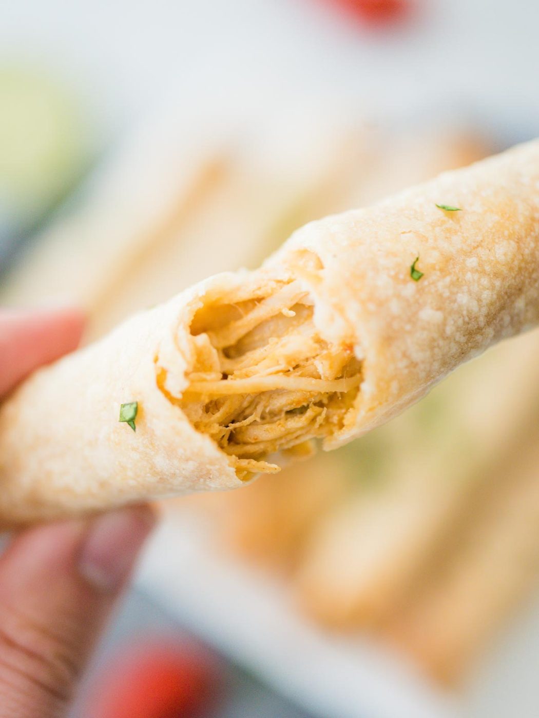 a chicken taquitos being torn apart