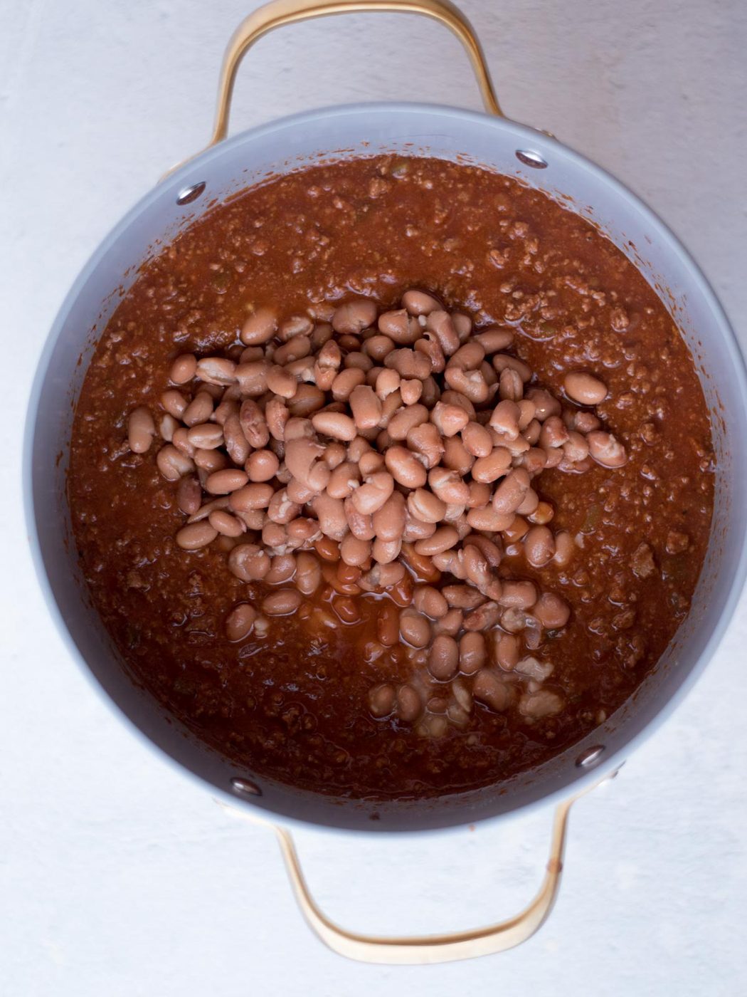 chili in a dutch oven with beans on top